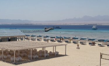 Plage de Bianca Island, cabanes bleues, ponton et bateaux d'excursion en mer Rouge
